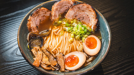 Delicious pork chashu ramen with tender marinated pork, tamago egg, and bamboo shoots in a beautiful bowl. Rich broth, perfect for Japanese cuisine lovers.