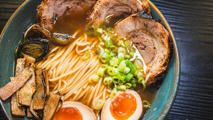 Delicious pork chashu ramen with tender marinated pork, tamago egg, and bamboo shoots in a beautiful bowl. Rich broth, perfect for Japanese cuisine lovers.