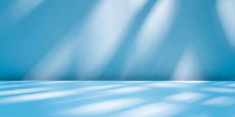 Abstract light blue background for product presentation with sunlight reflections and shadows on wall. Winter background.	