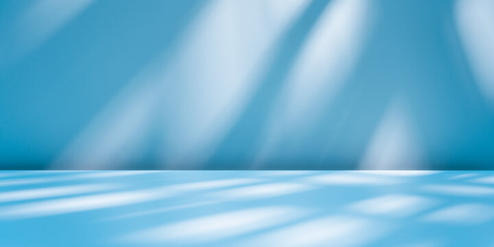 Abstract light blue background for product presentation with sunlight reflections and shadows on wall. Winter background.	
