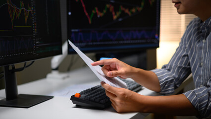 Photo Set of Close up A young trader working with financial charts on a computer at home, Future job opportunities in digital markets and stock exchange