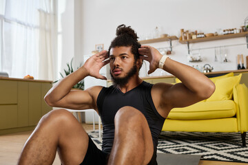 Focused athletic man trains indoors with determination during home workout session