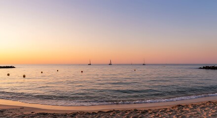 Naklejka premium Beautiful Sunset over Calm Ocean with Distant Sailboats and Sandy Beach.