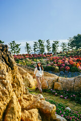 One Asian woman enjoying beautiful garden landscape on island in winter at Tongnayuwan (aka Anpingxianhe) in Daxin, Chongzuo, Guangxi, China