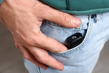 Man with hidden spy camera in his pocket, closeup
