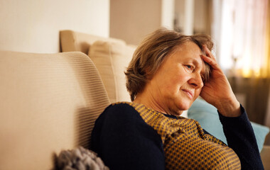 Close-up of an elderly woman suffering from a headache