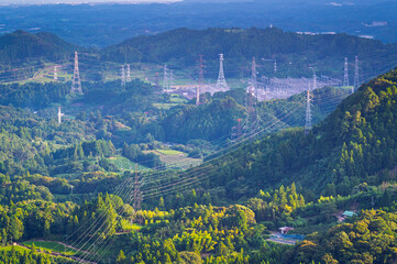 Fototapeta premium Row of green tea in tea farm plantation and mountain landscape of aerial view, Higashiyama, Shimada City, Shizuoka, Japan