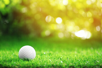 Golf ball on green grass outdoors. Sport and leisure