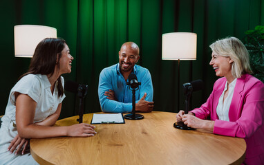Group of three diverse hosts having a podcast discussion