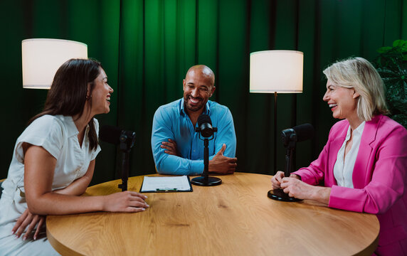 Group of three diverse hosts having a podcast discussion
