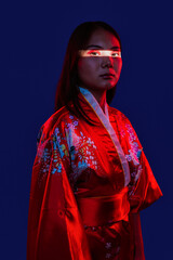 Asian woman wearing traditional kimono with red light
