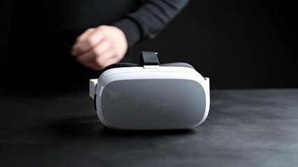 Virtual Reality Innovation: a sleek VR headset rests elegantly, with a hand approaching to interact. Showcasing the cutting-edge technology and immersive experience of the virtual world. - Powered by Adobe