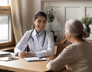 A woman doctor is talking to an older woman