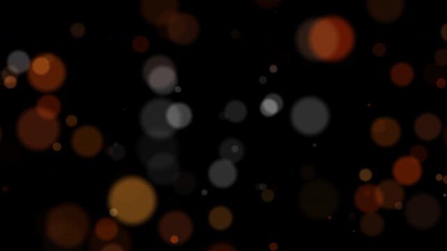 Abstract blurry bokeh with lights particles on dark background. This video includes a transparent Alpha Channel. ProRes 4444.