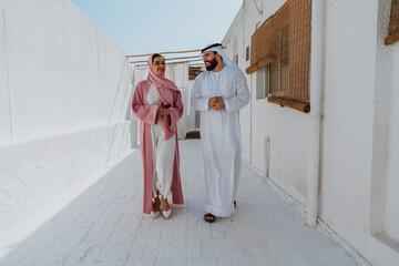 Emirati couple walking through a traditional garden together