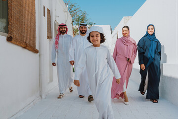 Arab family walking together smiling on white street