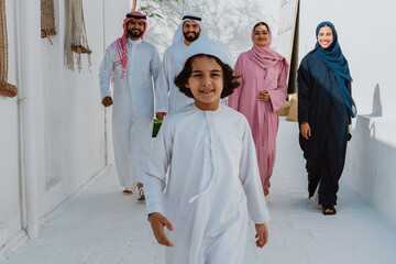 Arab family walking together smiling on white street