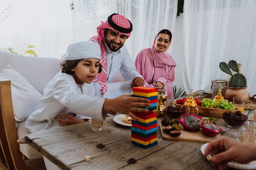 Arab family playing games together during ramadan celebration