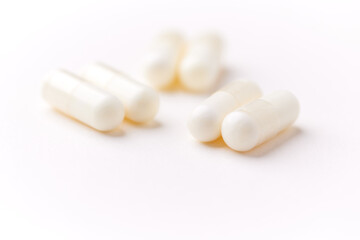 Creatine tablets on paper background. Soft focus. Close up. Copy space.	