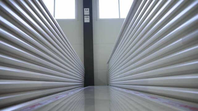 Stacked white windowsills with branded tape in manufacturing plant storage closeup. High quality sills prepared for shipment in warehouse