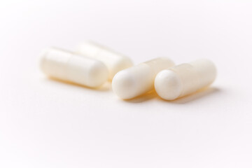 Creatine tablets on paper background. Soft focus. Close up. Copy space.	