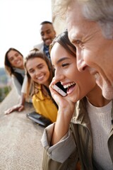Obraz premium Group of friends enjoying a cheerful moment while talking on the phone
