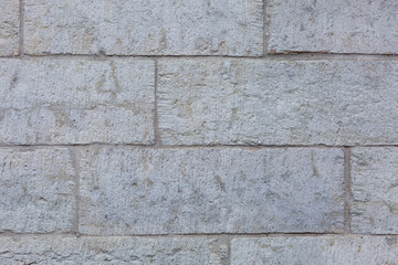 Gray wall made of large stones. Construction and architecture. Background. Space for text.