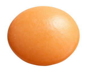 Lentil seed, lens-shaped and flat, featuring a soft orange hue.