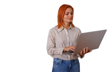 Woman with red hair standing, smiling, working on laptop, digital communication, professional businesswoman