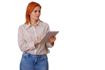Woman with red hair holding a tablet, browsing digital content. She is looking to the side, wearing casual business attire