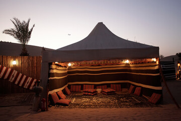 Arabian traditional tent in the middle of the desert for a family gathering in Dubai, United Arab Emirates, with Arab heritage.