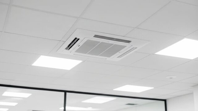 Clean office ceiling with a square central AC unit