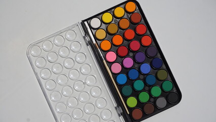 Palette with watercolors on a white background, top view