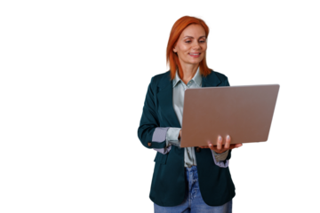 Professional woman with red hair standing, smiling, and holding a laptop, engaging in mobile business work