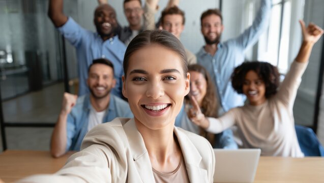 Happy team celebrating success with a joyful group selfie in the office - Powered by Adobe