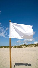Blank white flag on beach