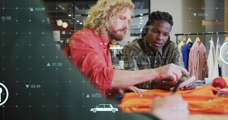 Two designers examining orange garment sample in retail showroom, with smartphone and data graphics