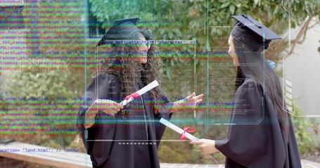 Standing teen graduates wearing black cap-and-gown attire on walkway, holding red-ribboned diplomas