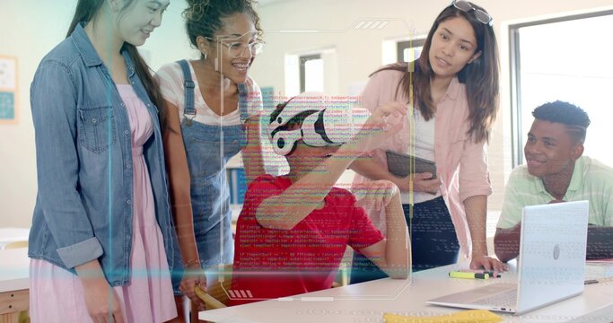 Interacting teen in red shirt wearing VR headset exploring VR content in classroom with instructor