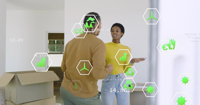 Sorting couple unpacking boxes in white room, with open box and hex overlays showing eco metrics