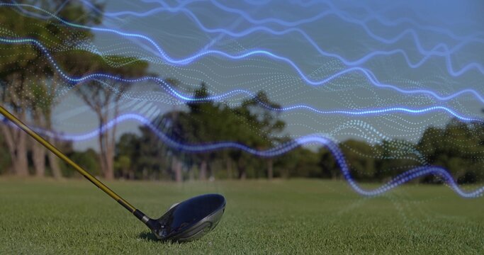 Leaning golf driver head and shaft on fairway grass with digital waveforms, tree line, copy space