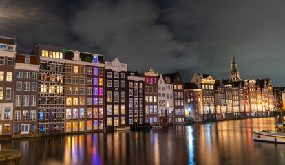 Amsterdam night city. Colorful houses canal water. lanterns evening reflection. Old Building architecture