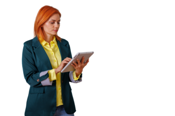 Redhead businesswoman standing and working with a digital tablet, managing her business tasks and connecting online