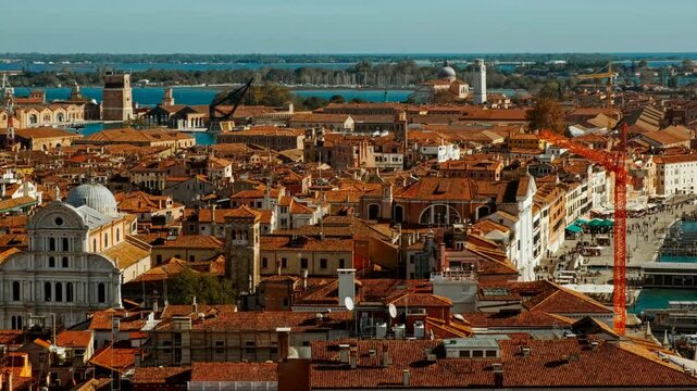 Aerial view of Venice, Veneto, Italy, revealing the lagoon city with canals, islands, church domes and red tiled roofs spreading toward the horizon