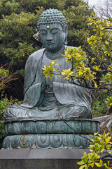 Beautiful large Buddha statue on lotus flower at Tennoji temple in Yanaka subsurb in Tokyo, Japan.