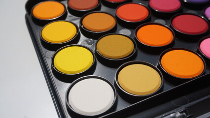 Palette of colorful eyeshadow palette on a white background
