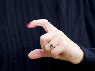 A hand signing the consonant letter 'C' in British Sign Language.BSL.Communication.Hearing Impaired