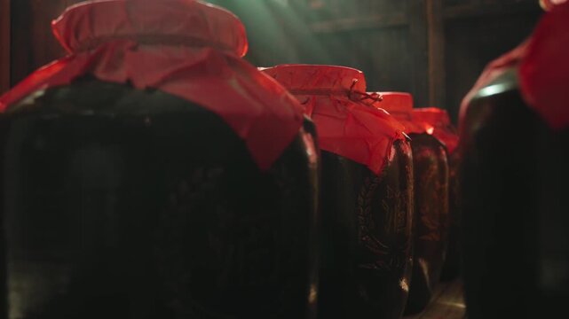 Glass Jars with Red Wax Seals in Wine Cellar Storage