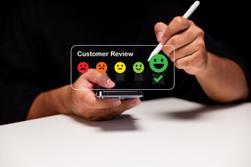 A person providing feedback using a mobile device, showcasing a customer review interface with emoticons for various satisfaction levels.