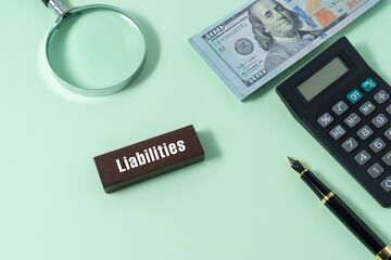 Business concept with a text Liabilities on wooden block